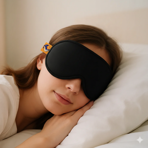 Person wearing a black sleep mask on a pillow